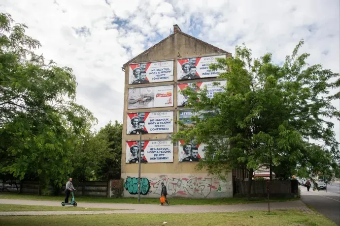 The building wall with propaganda billboards